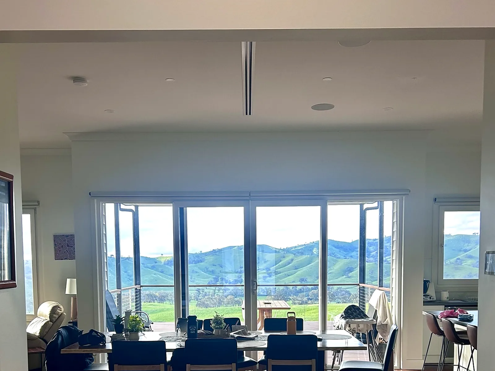 Dining and living space looking out over green hills from the Alexandra experience centre