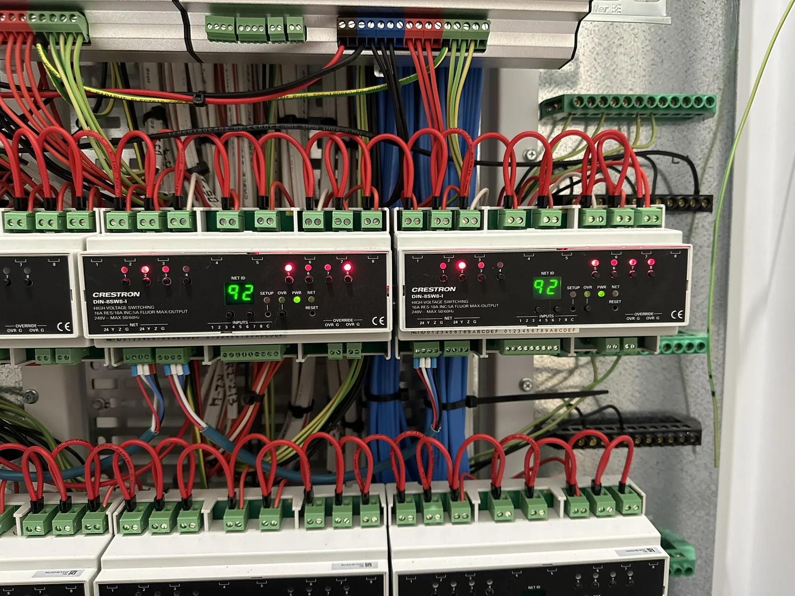 Crestron DIN switching modules neatly wired in a switchboard