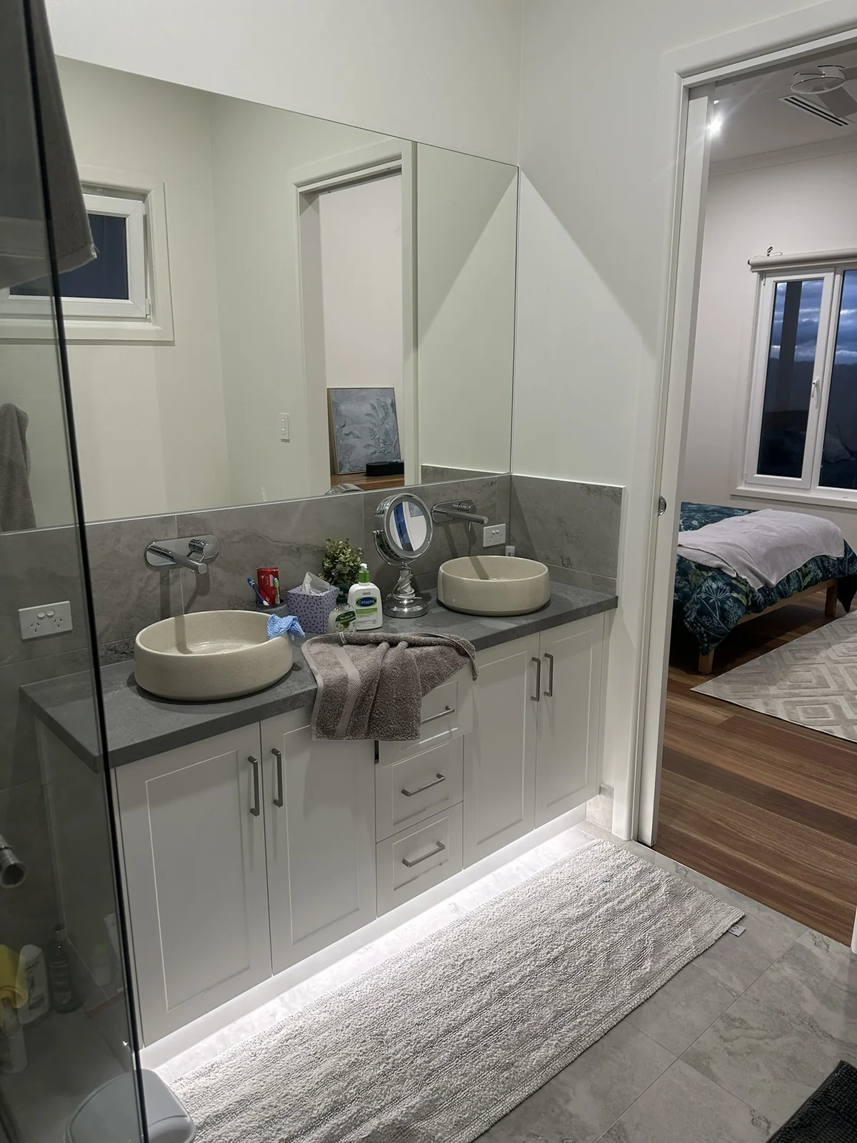 Bathroom vanity with soft toe-kick glow under the joinery